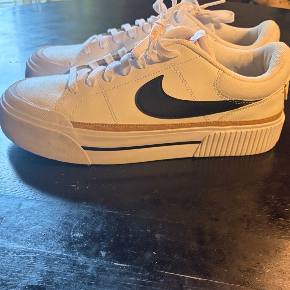 Nike White Low-Top Sneakers with Black Swoosh and Tan Stripe